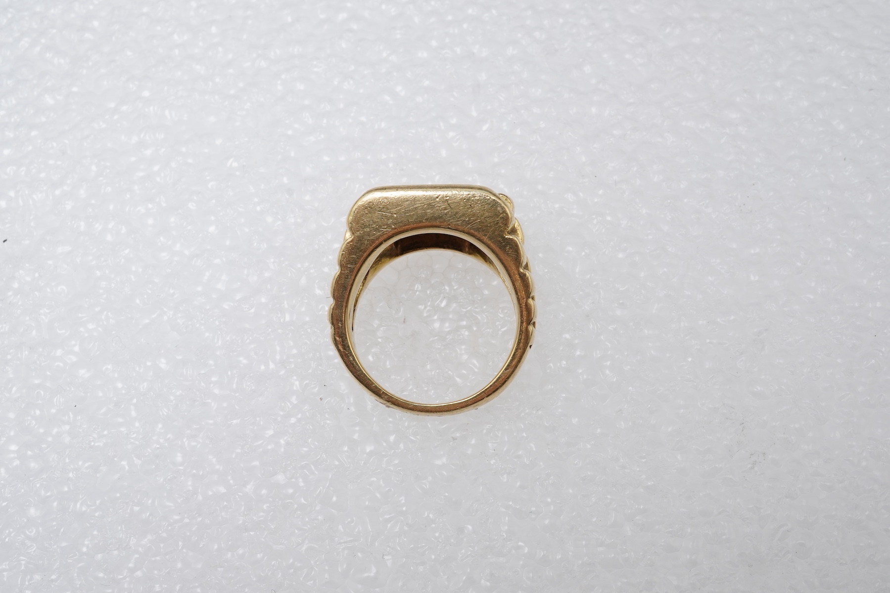 A gold and diamond signet ring